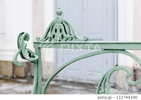 Green decoration design elements of an outdoor vintage forged railings 112748390