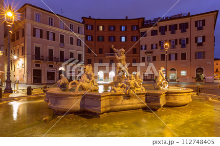 The famous fountains with tritons in Piazza Navona in Rome at dawn. 112748405