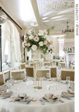 Elegant wedding reception venue with sophisticated decor and floral arrangements 112748746