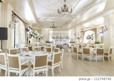 Elegant wedding reception venue with sophisticated decor and floral arrangements 112748748