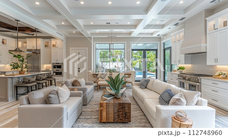 A Living Room With Abundant Furniture and Large Windows 112748960