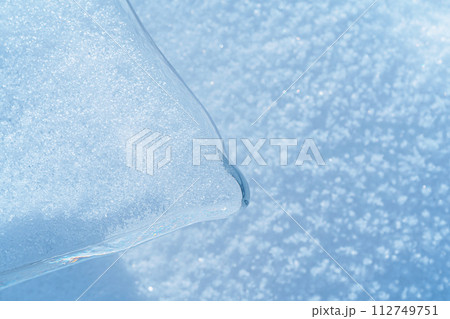 Ice hummocks covered in snow on Baikal Lake. Transparent blue ice floe. Natural background. Great backdrop for your design with copy space. Top view. 112749751