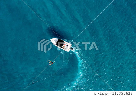 Boat and fallen in the water water skier, top view Boat and fallen in the water water skier, top view 112751623