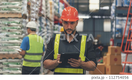 Warehouse management logistics team counting checking products on inventory shelf. Hispanic men worker check stock control in distribution storage. Teamwork shipment worker checklist quality control Warehouse management logistics team counting checking products on inventory shelf. Hispanic men worker check stock control in distribution storage. Teamwork shipment worker checklist quality control 112754056