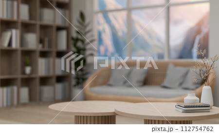 A close-up image of a minimal wooden coffee table in a comfortable, Scandinavian living room. 112754762