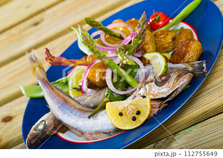 Stewed Blue Whiting fish with potatoes 112755649