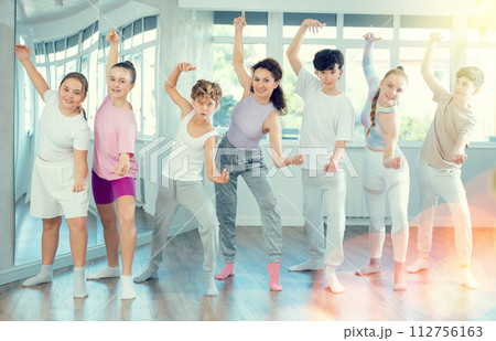 Group of children with teacher posing in studio 112756163
