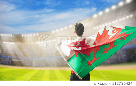 Wales supporters. Welsh football fans on stadium. Wales supporters. Welsh football fans on stadium. 112756424