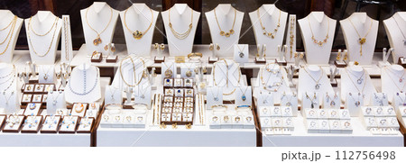 Pendants and bracelets with dimonds in jewelry store 112756498