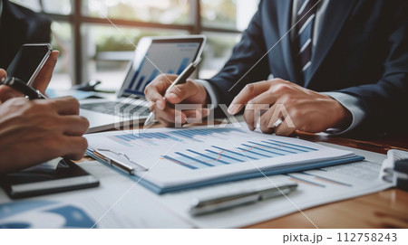 Business partners meeting and analyzing statistic financial with graph in office. Business partners meeting and analyzing statistic financial with graph in office. 112758243