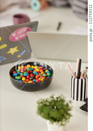 Vertical background image of meeting table or desk in office with bowl of colorful candy 112759312