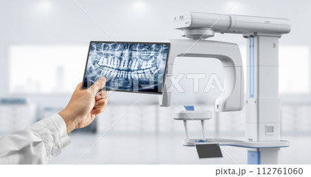 Dentist analyze digital x-ray film from scanner machine 112761060