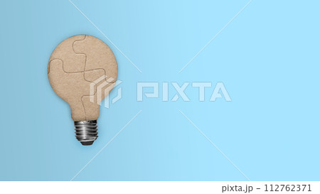 Closeup view of light bulb from a piece of the puzzle for unity and teamwork Closeup view of light bulb from a piece of the puzzle for unity and teamwork 112762371