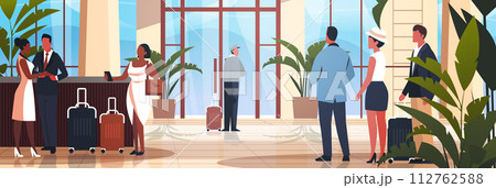 tourists with luggage departing from business trip standing at reception desk in hotel lobby recreation travel check-in concept 112762588