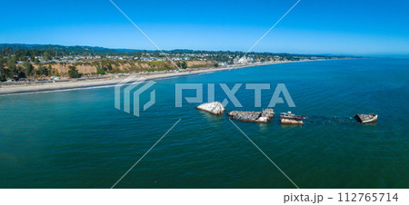 Old tanker ship wreck near the coast of California, USA. Now home to many birds like pelicans and sea gulls. Ship wreck aerial view. 112765714
