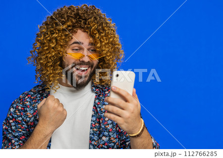 Happy excited winner man use smartphone celebrating success, winning play game, good lottery news Happy excited winner man use smartphone celebrating success, winning play game, good lottery news 112766285