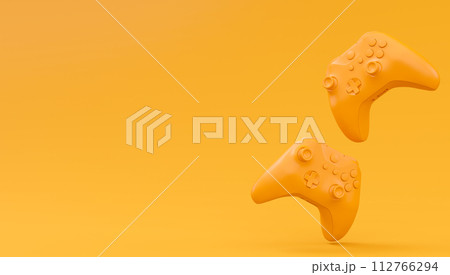 Video game joysticks or gamepads in plain monochrome yellow color background Video game joysticks or gamepads in plain monochrome yellow color background 112766294