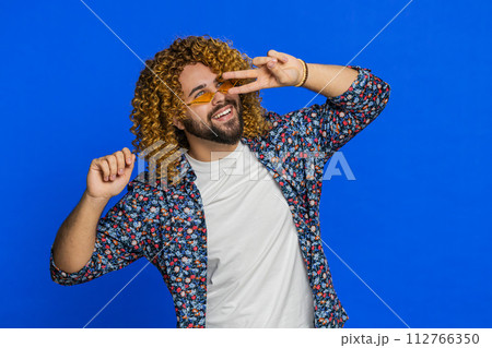 Caucasian stylish man wearing sunglasses dancing celebrating success victory winning success Caucasian stylish man wearing sunglasses dancing celebrating success victory winning success 112766350
