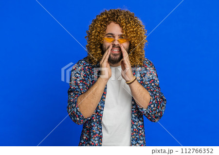 Caucasian young man whisper news rumors holding hands near mouth share gossip quiet keep my secrets 112766352