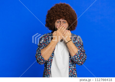 Frightened stylish man closing mouth with hands refusing to tell terrible secret, unbelievable truth Frightened stylish man closing mouth with hands refusing to tell terrible secret, unbelievable truth 112766418
