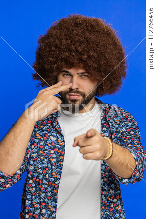 Man pointing at his eyes and camera show I am watching you gesture spying watching on someone 112766456