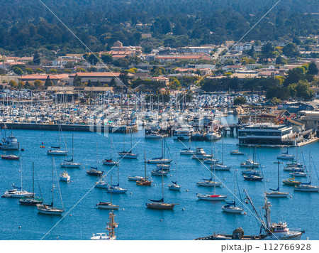 Beautiful aerial view of the Monterey town in California with many yachts docked by the pier. 112766928