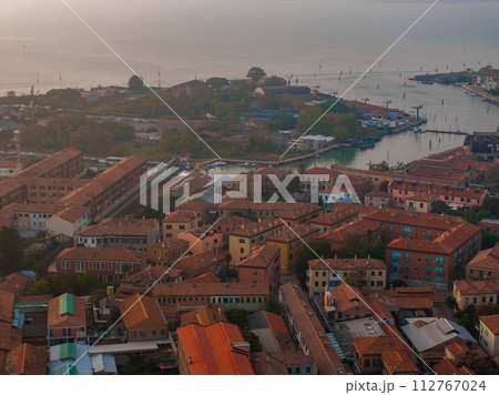 Aerial view of Murano island in Venetian lagoon sea from above, Italy at sunset Aerial view of Murano island in Venetian lagoon sea from above, Italy at sunset 112767024
