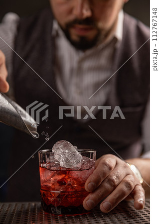 Bartender pouring cocktail at bar Bartender pouring cocktail at bar 112767148