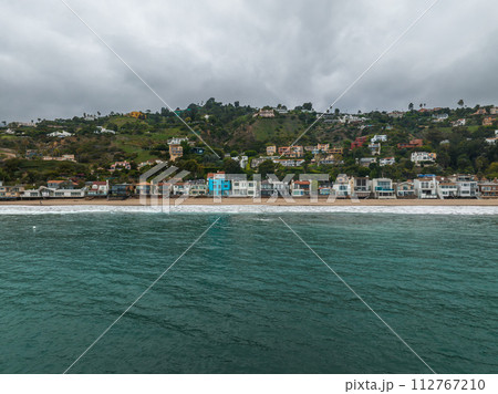 Malibu beach aerial view in California near Los Angeles, USA. Waves hitting the shore near expensive houses in Malibu. 112767210