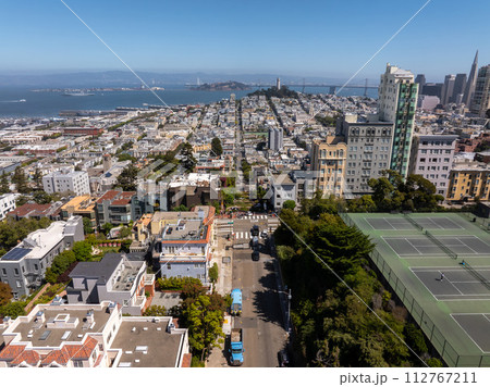 Panoramic view of aerial Lombard Street, an east west street in San Francisco, California. Famous for steep, one block section with eight hairpin turns. Crookedest, steep hills, sharp curves Panoramic view of aerial Lombard Street, an east west street in San Francisco, California. Famous for steep, one block section with eight hairpin turns. Crookedest, steep hills, sharp curves 112767211
