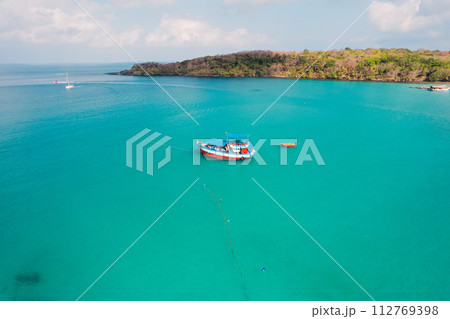 Boat on clear blue water on island Boat on clear blue water on island 112769398