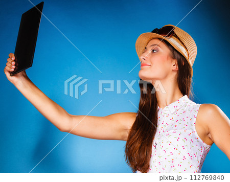girl using tablet taking picture of herself girl using tablet taking picture of herself 112769840