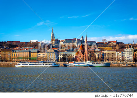 View of the Buda from Pest. The Fisherman's Bastion, the Matthias Church and Protestant church. Budapest, Hungary 112770744