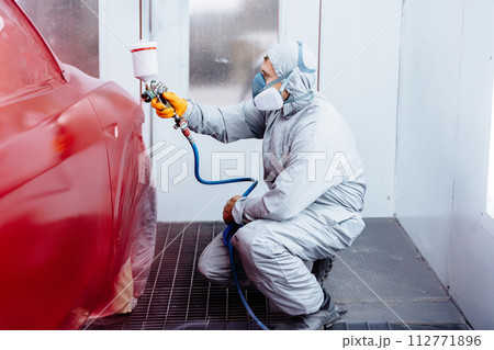 Car airbrush painting service and auto body repair process. Red color freshly painted car service center auto repair body paint workshop auto service. 112771896