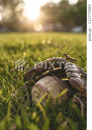 Baseball and Glove on Green Field at Sunset Baseball and Glove on Green Field at Sunset 112772064