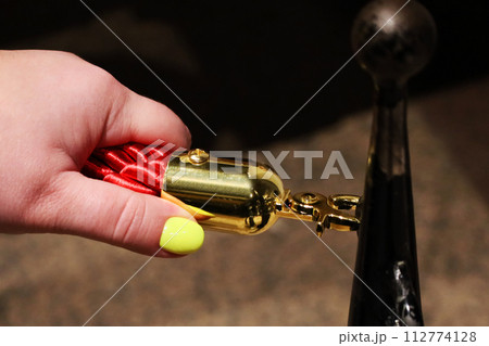 Gold colored metal stanchions with red velvet rope for crowd control Gold colored metal stanchions with red velvet rope for crowd control 112774128