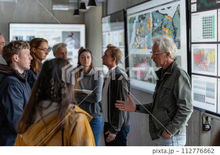 AI-generated content. Diversity at workplace - elderly man presenting information to younger colleagues 112776862