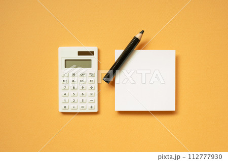 Office supply. Calculator, notepad, pencil on orange desk background. flat lay, top view, copy space 112777930