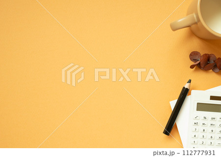 Workspace concept. Notepad, pencil, calculator, mug cup, plant on orange desk background. flat lay, top view, copy space Workspace concept. Notepad, pencil, calculator, mug cup, plant on orange desk background. flat lay, top view, copy space 112777931