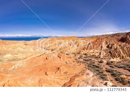 landscape of Skazka canyon on Issyk-Kul lake. Rocks Fairy Tale famous destination in Kyrgyzstan. Mountain like great wall of china and Rainbow Mountains of Danxia or Antelope crevice USA, Central Asia 112779345
