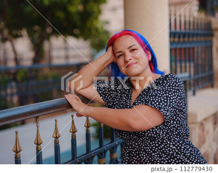 female summer old town walk in Antalya Turkey. woman with colorful hair and dress gracefully explores its historic streets. creating visual symphony that harmonizes past and present. female summer old town walk in Antalya Turkey. woman with colorful hair and dress gracefully explores its historic streets. creating visual symphony that harmonizes past and present. 112779430