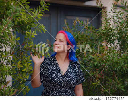 female summer old town walk in Antalya Turkey. woman with colorful hair and dress gracefully explores its historic streets. creating visual symphony that harmonizes past and present. female summer old town walk in Antalya Turkey. woman with colorful hair and dress gracefully explores its historic streets. creating visual symphony that harmonizes past and present. 112779432