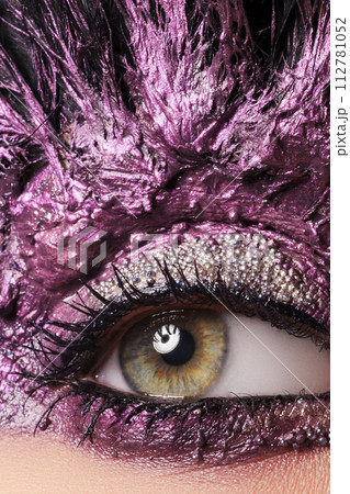 Young pretty woman face with false feather Young pretty woman face with false feather 112781052