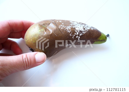 The pear became moldy. A mold or mould. The dust-like, colored appearance of molds is due to the formation of spores containing fungal secondary metabolites. Perishable food products. White background 112781115