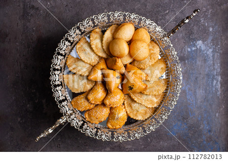 Delectable pastries arranged beautifully on a silver platter. 112782013