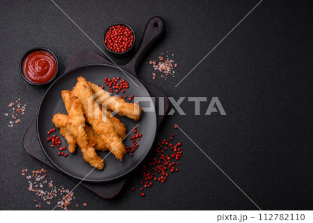 Delicious fresh chicken or turkey strips or nuggets breaded with salt and spices 112782110