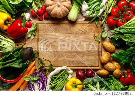 Vegetables background. Various vegetables on kitchen table. Clean eating, healthy food concept, flat lay, top down view Vegetables background. Various vegetables on kitchen table. Clean eating, healthy food concept, flat lay, top down view 112782998
