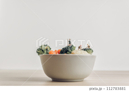 Full bowl of fresh salad green harvested by miniature farmers Full bowl of fresh salad green harvested by miniature farmers 112783881