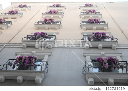 a building with a lot of windows and balconies on it 112785919