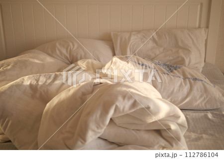 messy bed in early morning , messy bed after waking up  112786104